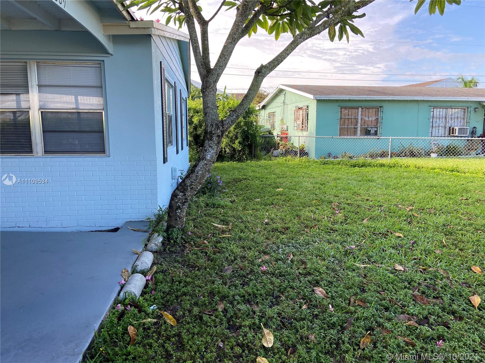 1509 Pine Tree Court Riviera Beach, FL 33404 - Photo 4 of 19 a house view with a garden space