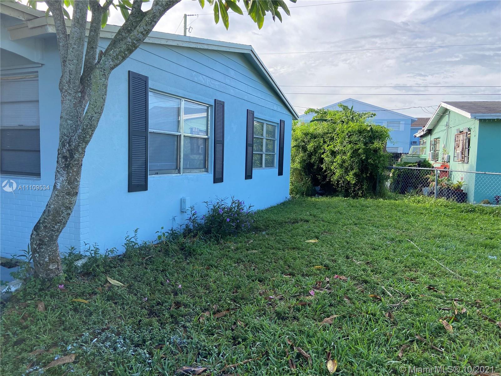 1509 Pine Tree Court Riviera Beach, FL 33404 - Photo 5 of 19 a view of front of a house with a yard