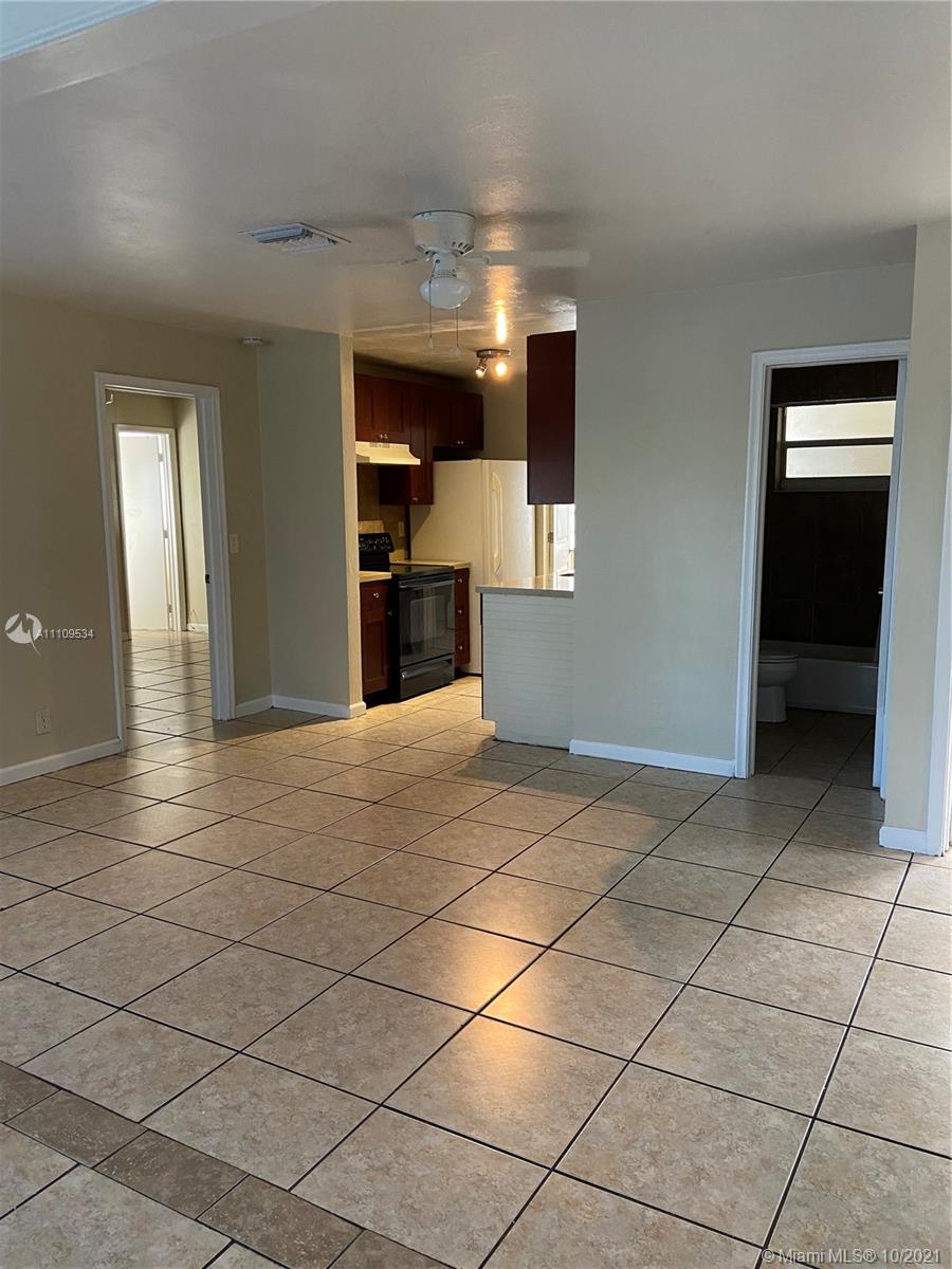 1509 Pine Tree Court Riviera Beach, FL 33404 - Photo 8 of 19 a view of a livingroom and a bathroom with a sink and a mirror