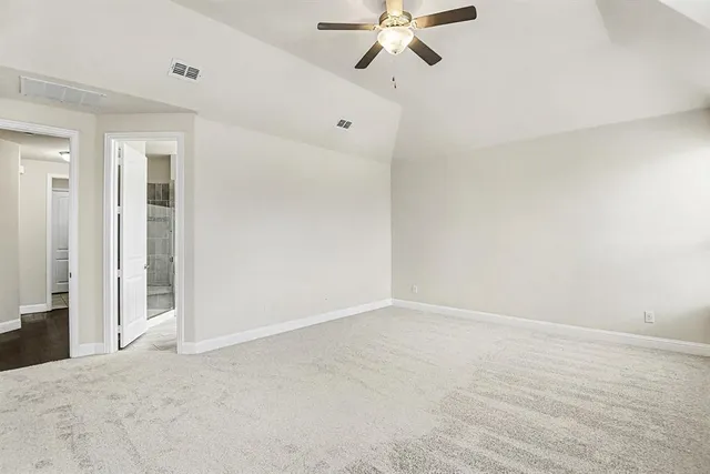 a view of an empty room with a fan