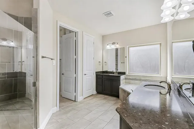 a view of a bathroom with a tub shower and mirror