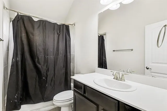 a bathroom with a sink a toilet a mirror and vanity