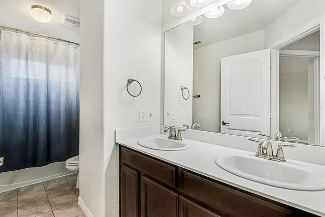 a bathroom with a double vanity sink and a mirror