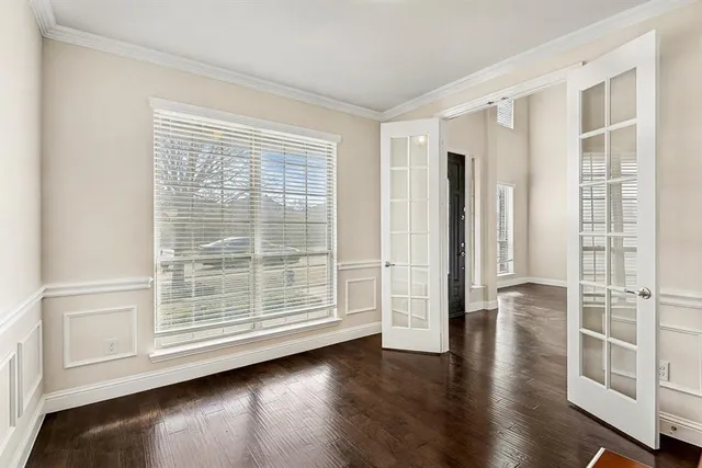 a view of wooden floor and windows in a room