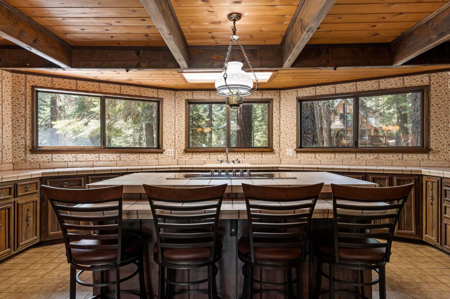 1131 Lake Ridge Road Lake Almanor, CA 96137 - Photo 15 of 55 a kitchen with a stove a sink and chairs