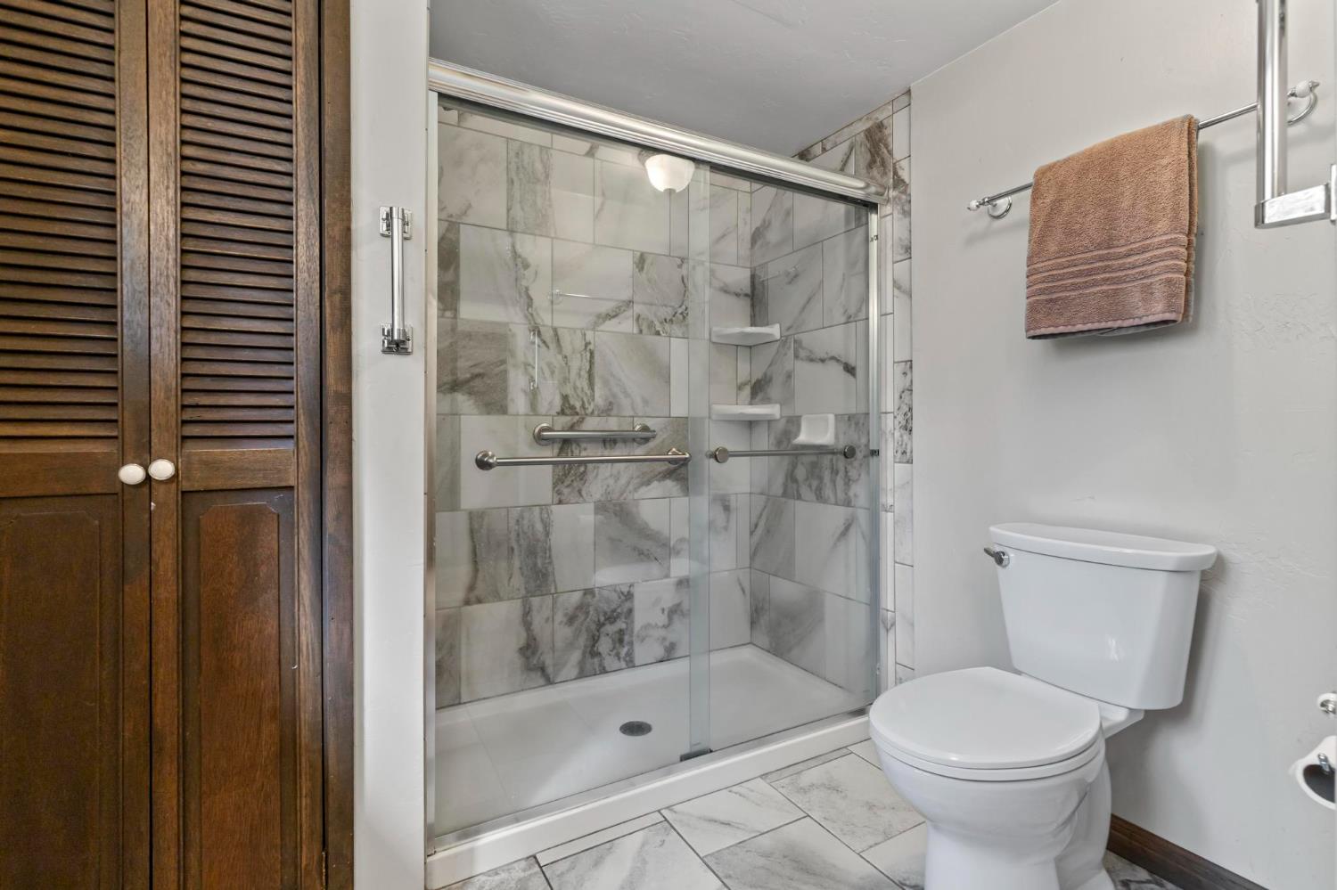 1131 Lake Ridge Road Lake Almanor, CA 96137 - Photo 40 of 55 a bathroom with a shower and a toilet