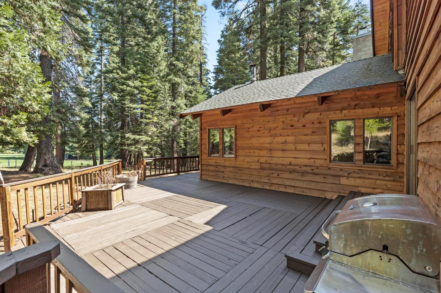 1131 Lake Ridge Road Lake Almanor, CA 96137 - Photo 45 of 55 a backyard of a house with wooden floor and outdoor seating