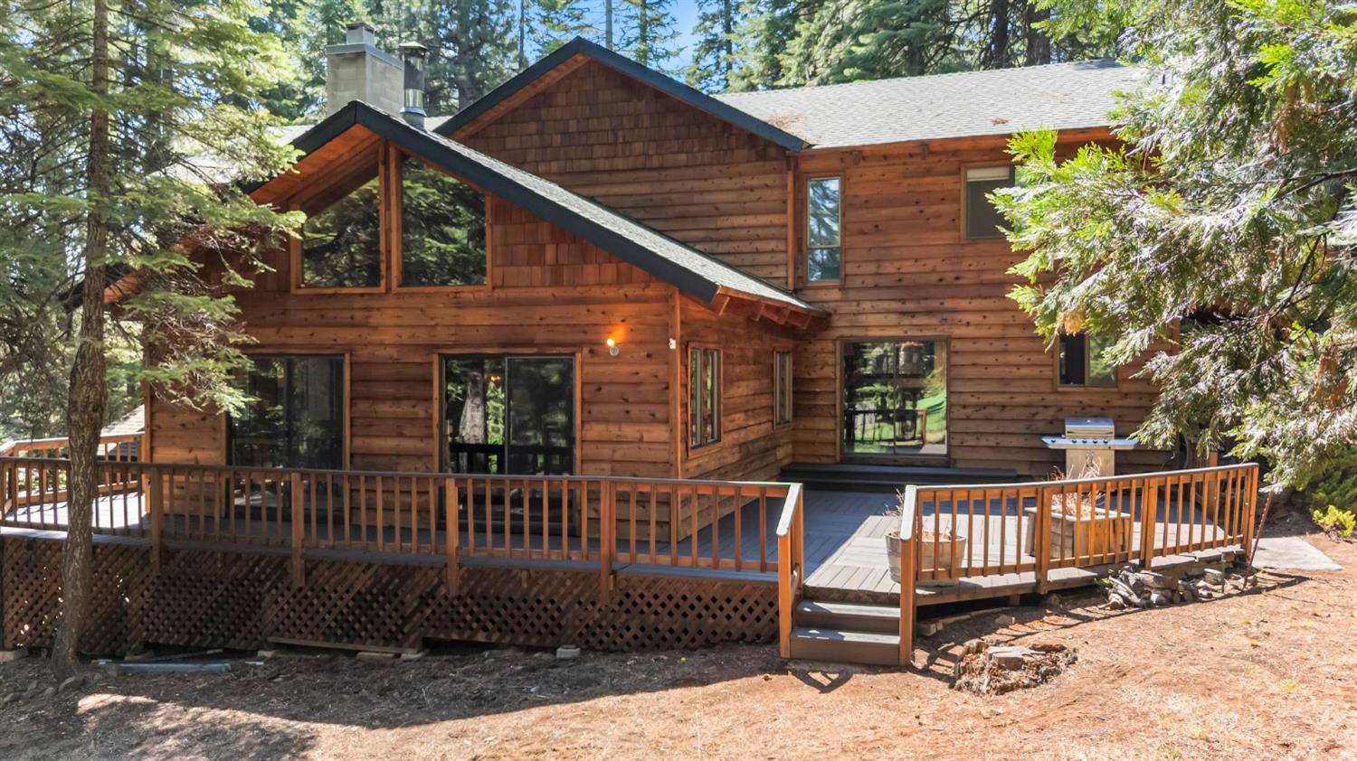 1131 Lake Ridge Road Lake Almanor, CA 96137 - Photo 6 of 55 a view of a small house with wooden fence