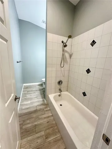 a bathroom with a bathtub and shower
