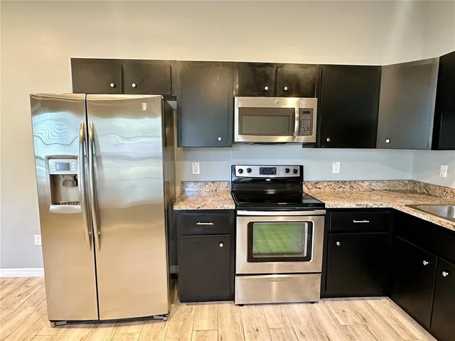 a kitchen with a sink and stainless steel appliances