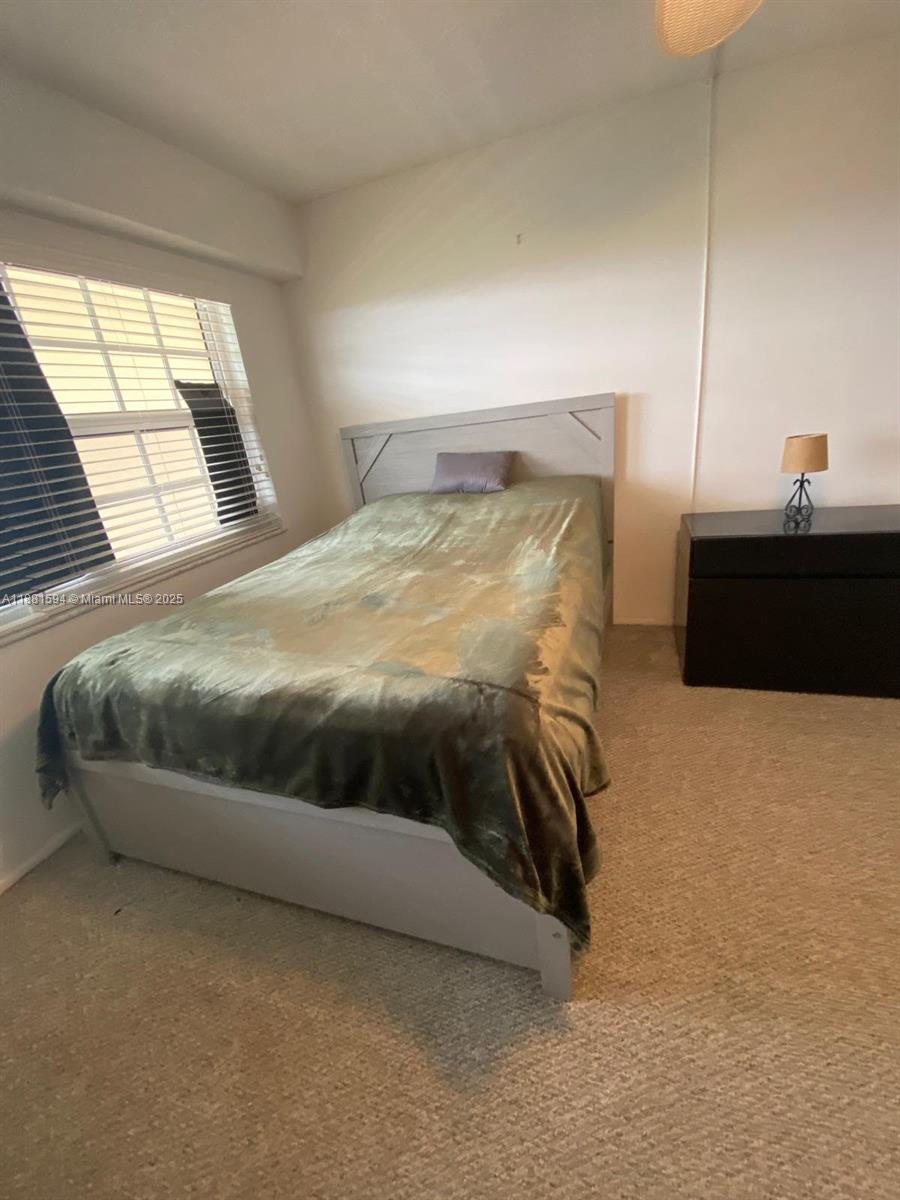 3507 Oaks Way, Unit 804 Pompano Beach, FL 33069 - Photo 12 of 26 a bedroom with a bed and a window