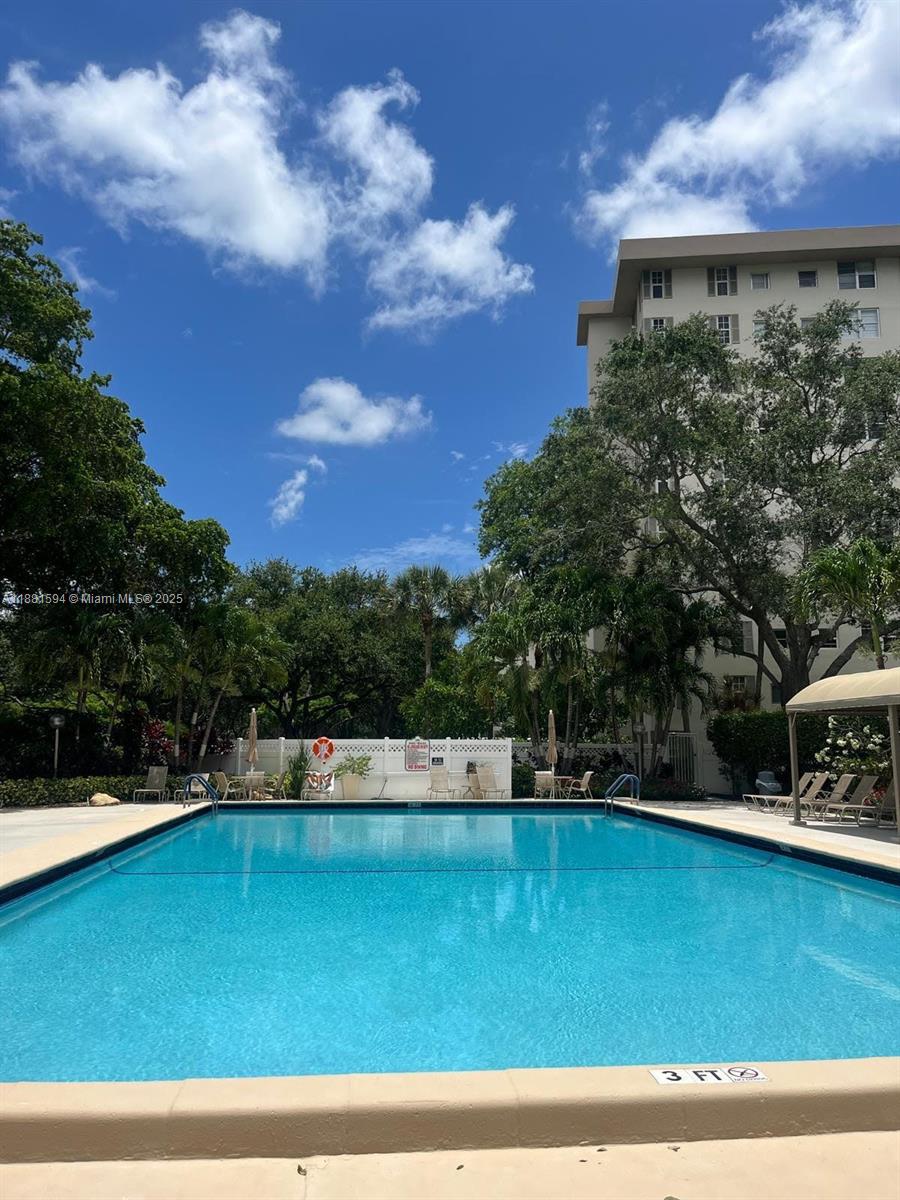 3507 Oaks Way, Unit 804 Pompano Beach, FL 33069 - Photo 17 of 26 a view of a swimming pool with a yard