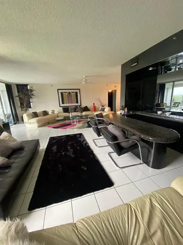 a living room with furniture and a pool table