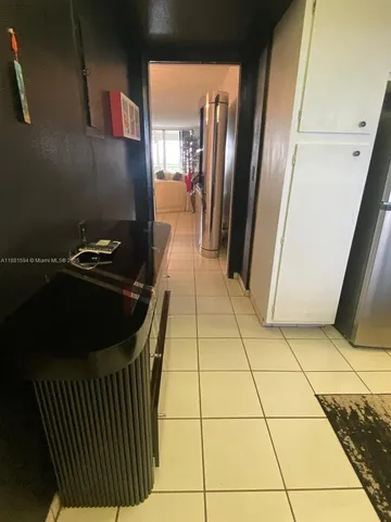 a kitchen with a sink a refrigerator and washer