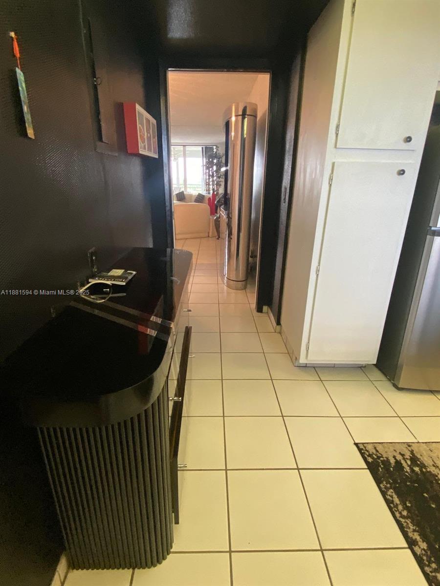 3507 Oaks Way, Unit 804 Pompano Beach, FL 33069 - Photo 8 of 26 a kitchen with a sink a refrigerator and washer