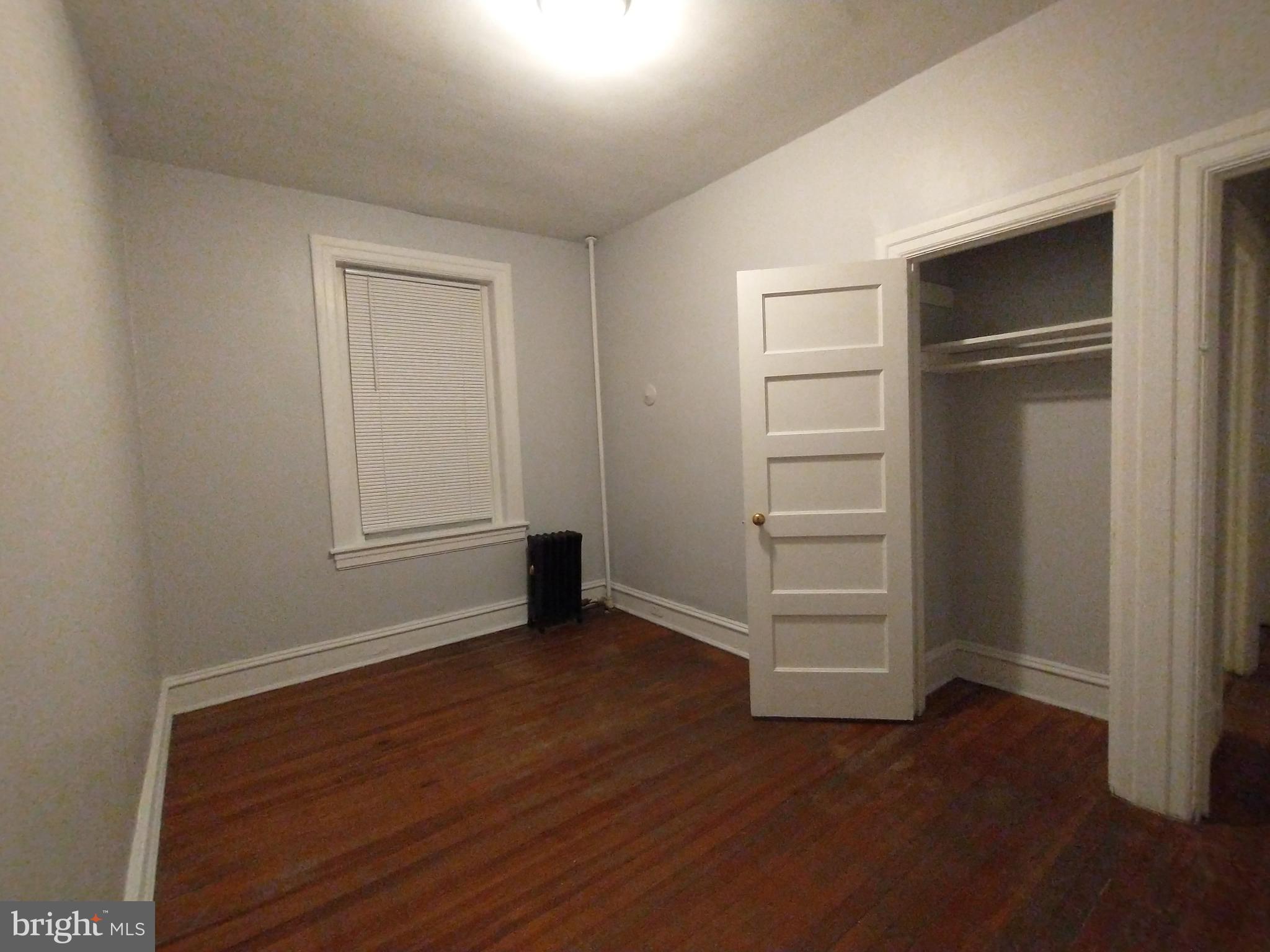 307 Dolphin Street, Unit 3C Baltimore, MD 21201 - Photo 12 of 14 a view of an empty room with closet and a window