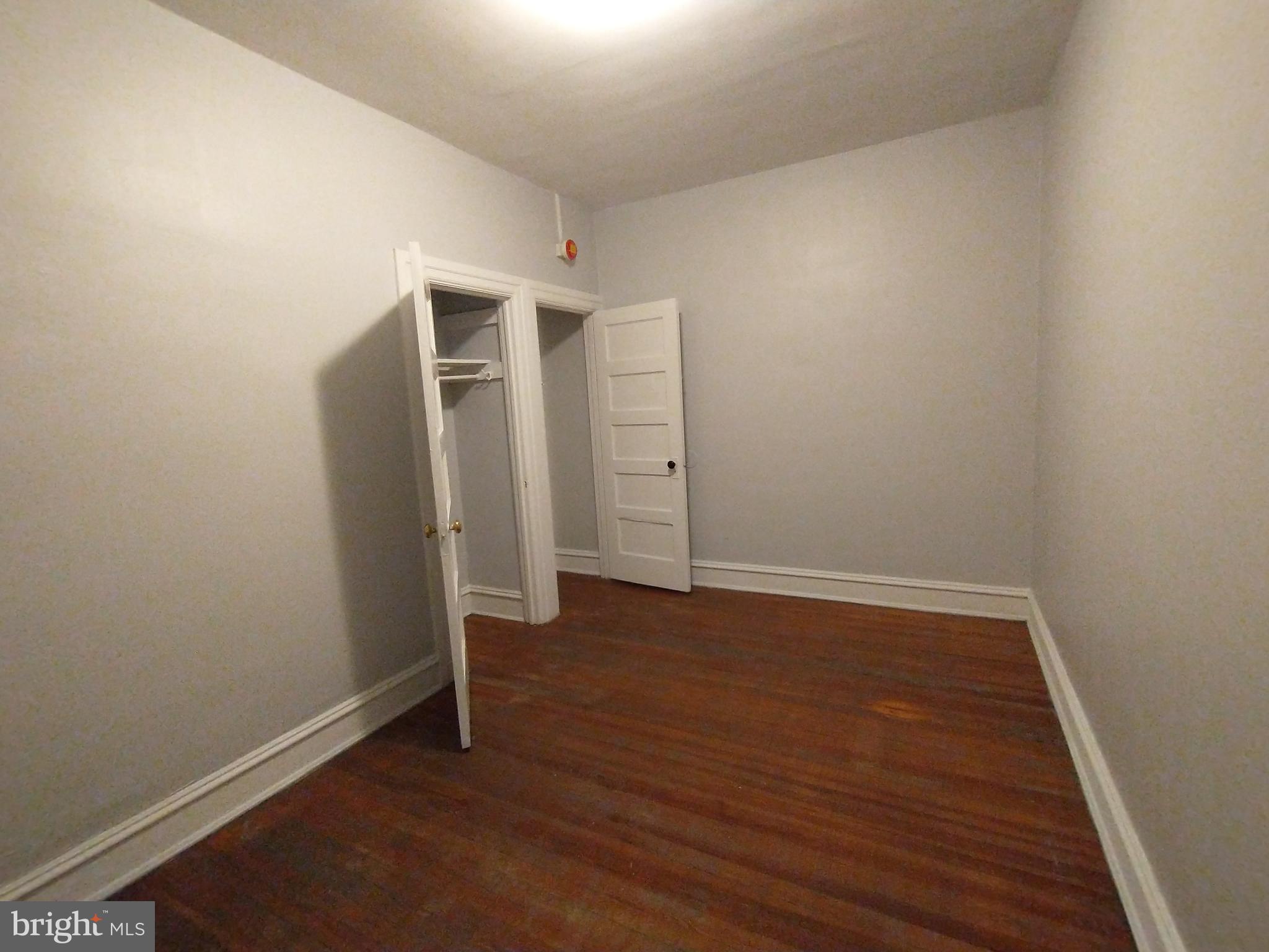 307 Dolphin Street, Unit 3C Baltimore, MD 21201 - Photo 13 of 14 an empty room with wooden floor and closet