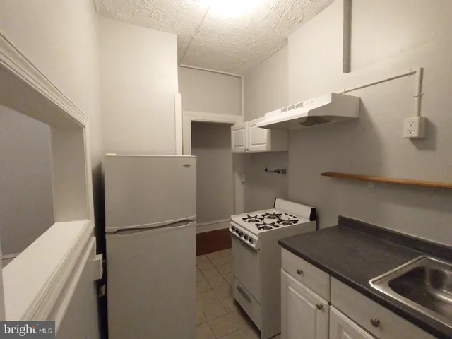a kitchen with stainless steel appliances a refrigerator and a stove