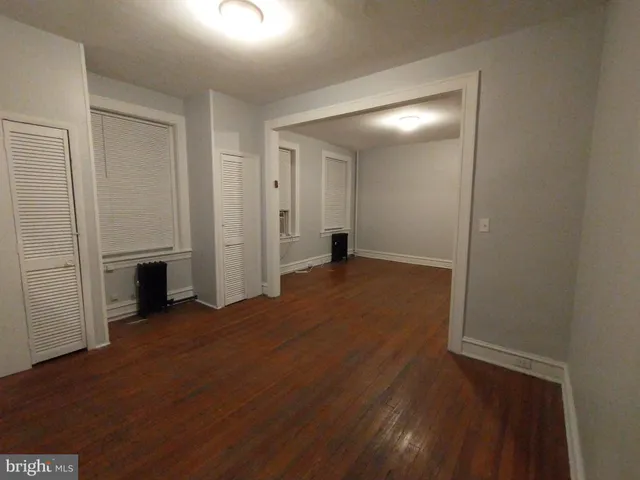 a view of a big room with wooden floor and fireplace