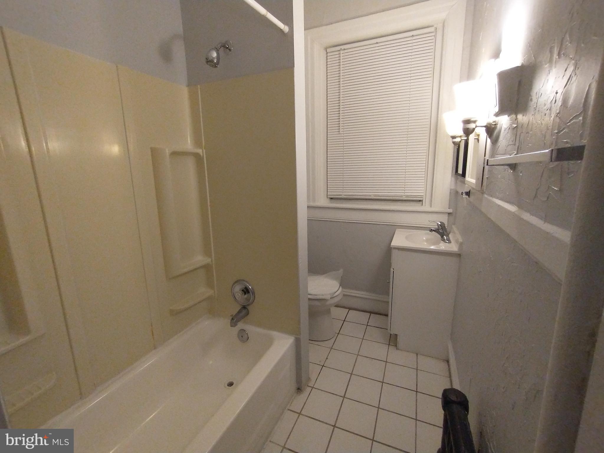307 Dolphin Street, Unit 3C Baltimore, MD 21201 - Photo 9 of 14 a bathroom with a sink a toilet and shower