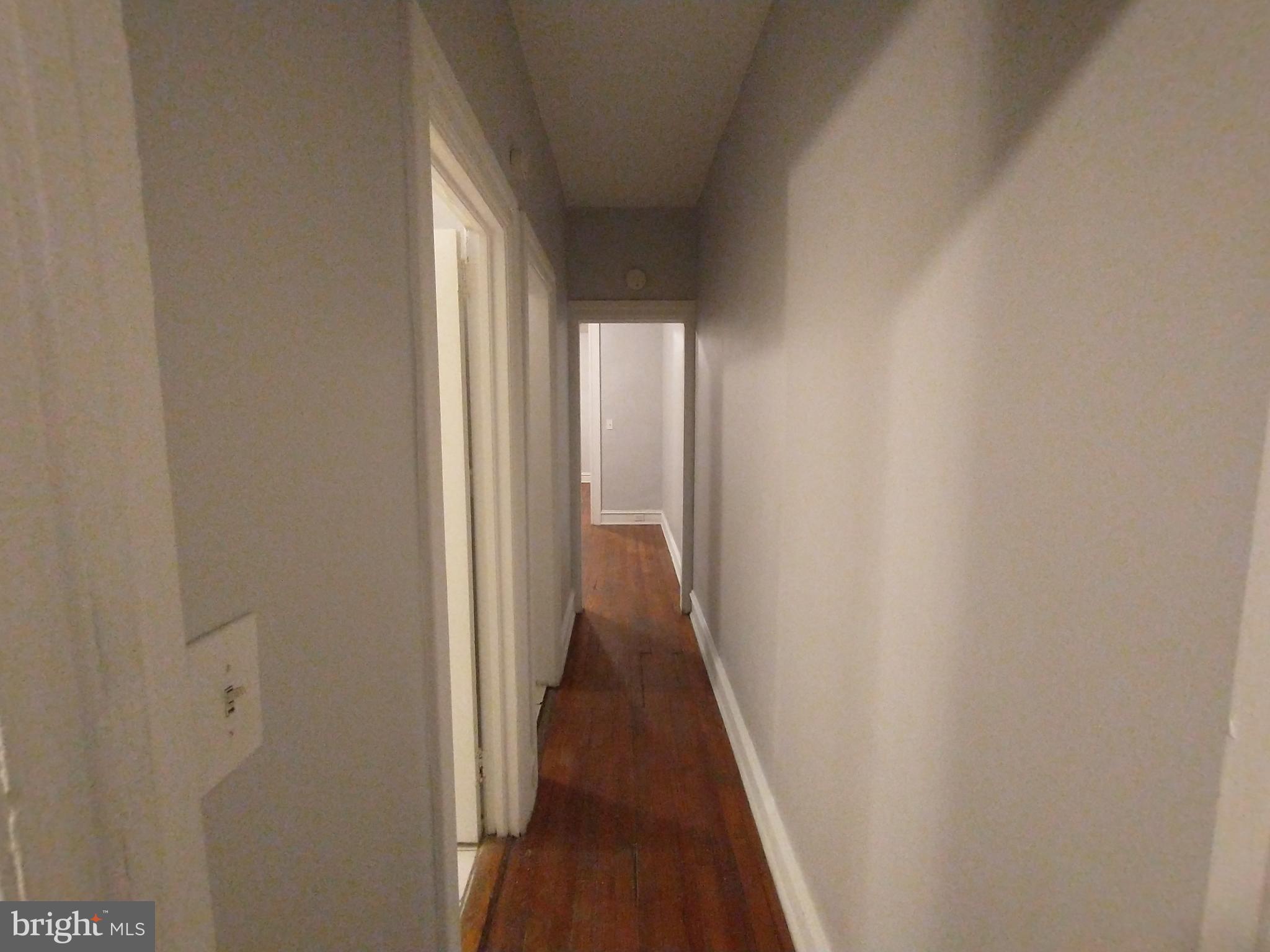 307 Dolphin Street, Unit 3C Baltimore, MD 21201 - Photo 10 of 14 a view of a hallway with wooden floor