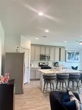 a kitchen with kitchen island a sink stove and refrigerator