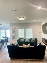 206 John House Lane Rosharon, TX 77583 - Photo 5 of 15 a living room with furniture and a fireplace