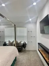 a bedroom with furniture and a window