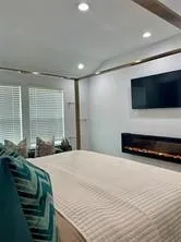 a bedroom with a bed and a flat screen tv