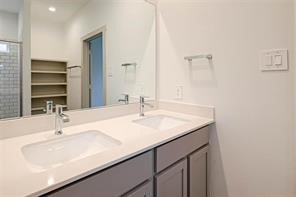 206 John House Lane Rosharon, TX 77583 - Photo 9 of 15 a bathroom with a sink and a mirror