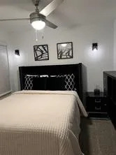 a bed sitting in a bedroom and chandelier
