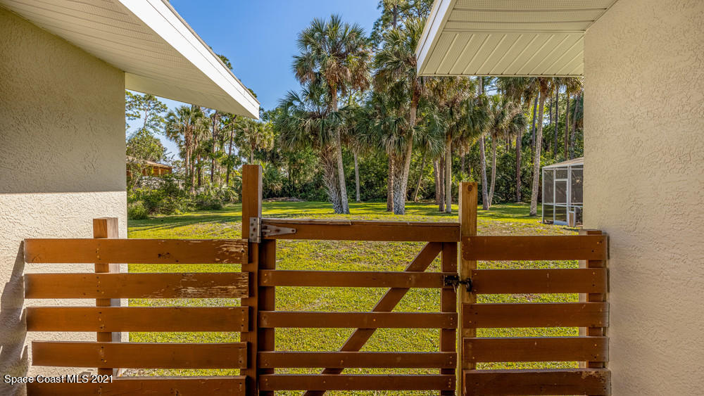 4211 Mustang Road Melbourne, FL 32934 - Photo 53 of 61 038_gate_to_back_yard
