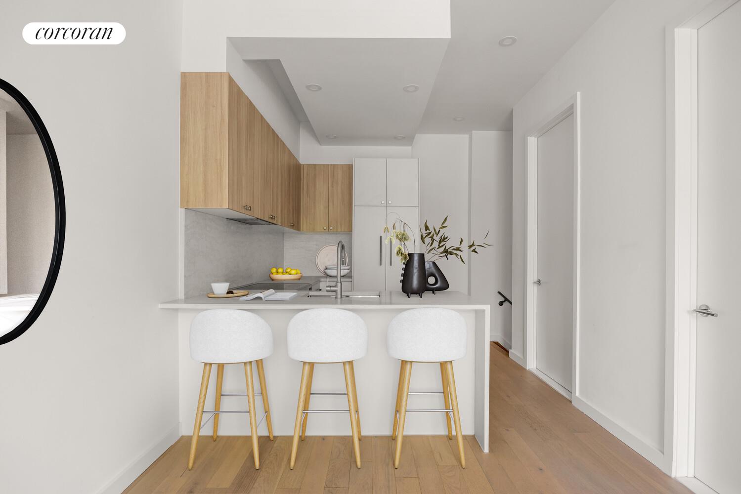 48 Stanhope Street, Unit 1F Brooklyn, NY 11221 - Photo 2 of 11 a kitchen with stainless steel appliances granite countertop a dining table chairs and a refrigerator