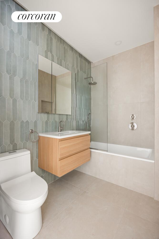 48 Stanhope Street, Unit 1F Brooklyn, NY 11221 - Photo 6 of 11 a bathroom with a sink a toilet and bathtub