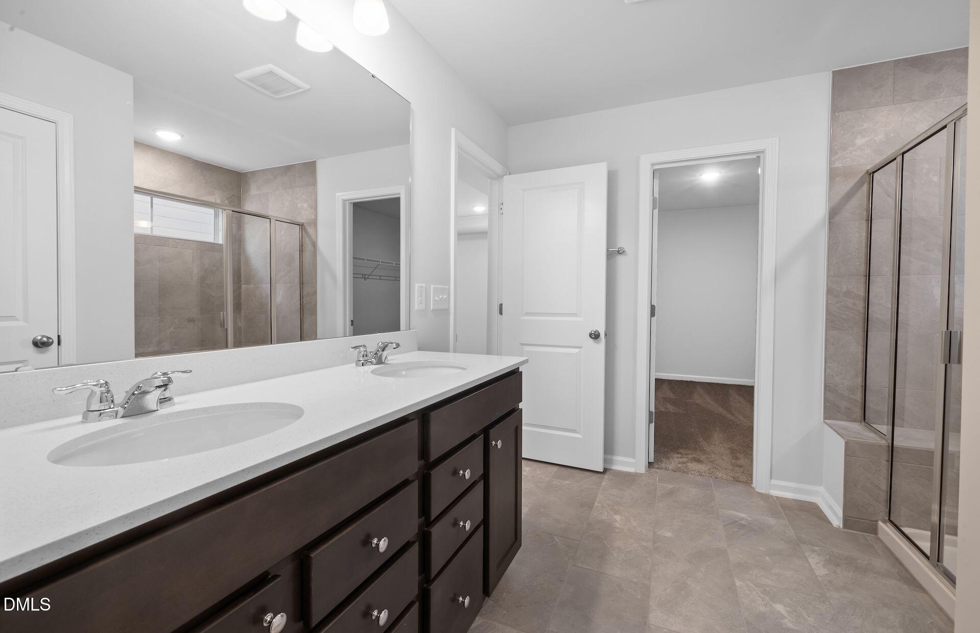 437 Grange Farm Place Raleigh, NC 27603 - Photo 13 of 34 a bathroom with a double vanity sink a and mirror