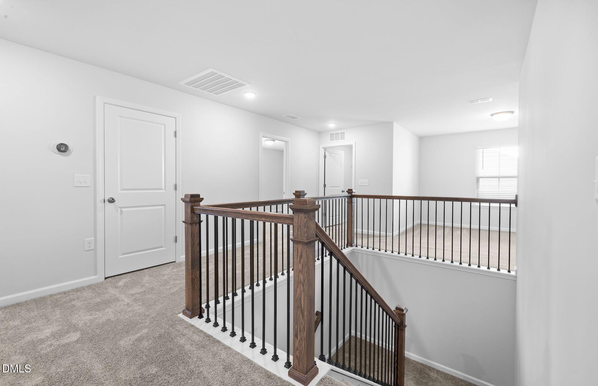 437 Grange Farm Place Raleigh, NC 27603 - Photo 15 of 34 a view of a hallway with wooden floor and windows