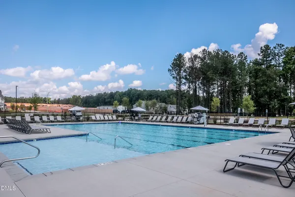 a view of a swimming pool and lounge chairs