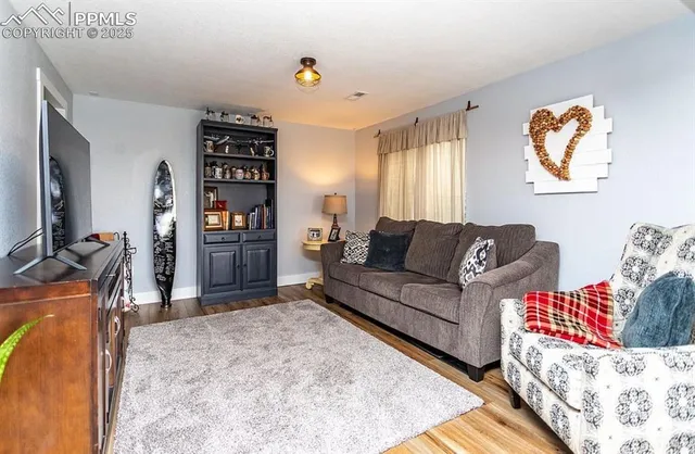 a living room with furniture and a flat screen tv