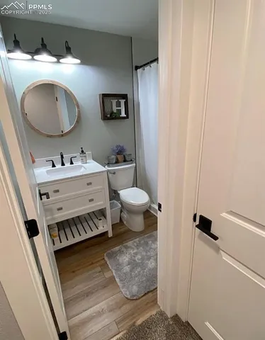 a bathroom with a sink toilet and mirror