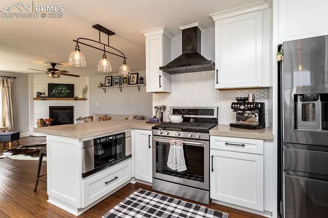 a white stove top oven sitting inside of a kitchen