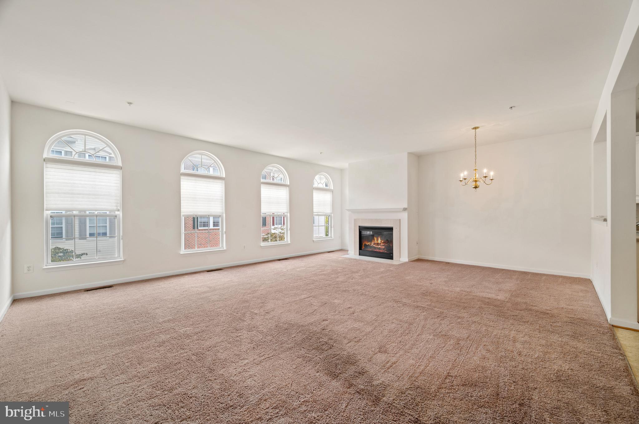 7122 Silverleaf Oak Road, Unit 227 Elkridge, MD 21075 - Photo 12 of 55 an empty room with windows and fireplace