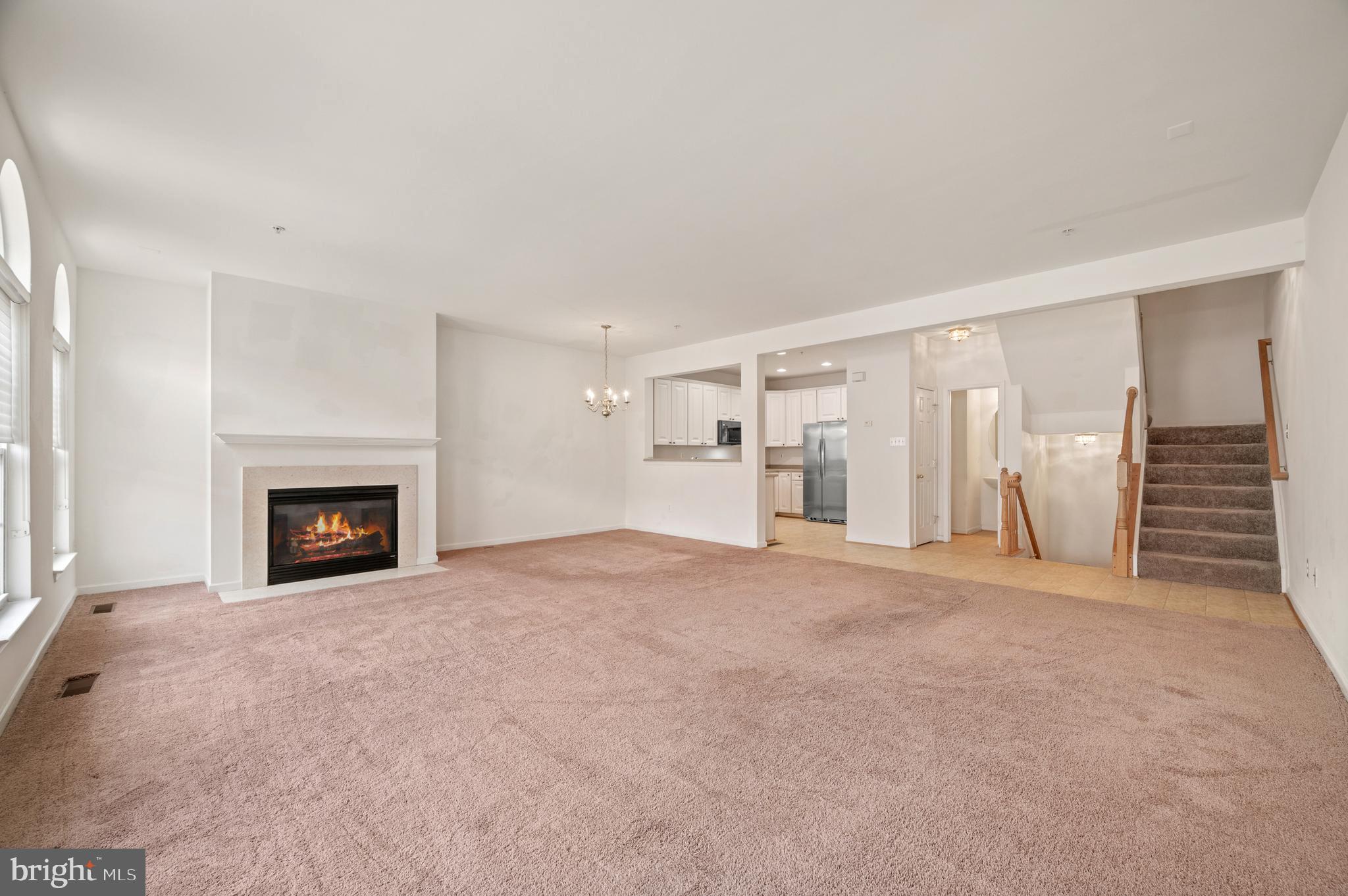 7122 Silverleaf Oak Road, Unit 227 Elkridge, MD 21075 - Photo 15 of 55 a view of an empty room with a fireplace and a window