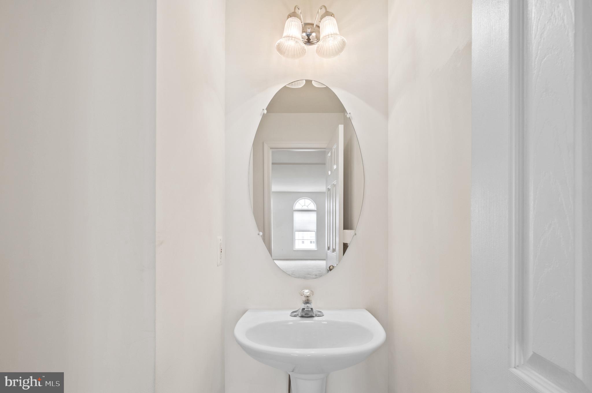 7122 Silverleaf Oak Road, Unit 227 Elkridge, MD 21075 - Photo 18 of 55 a bathroom with a sink and a mirror