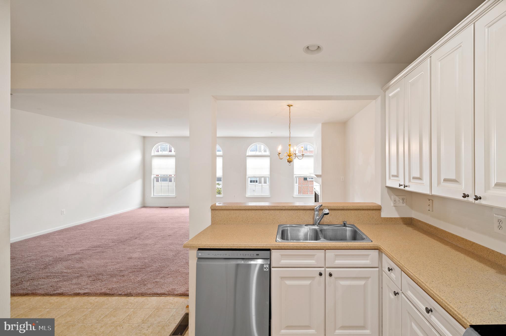 7122 Silverleaf Oak Road, Unit 227 Elkridge, MD 21075 - Photo 21 of 55 a kitchen with a sink cabinets and window