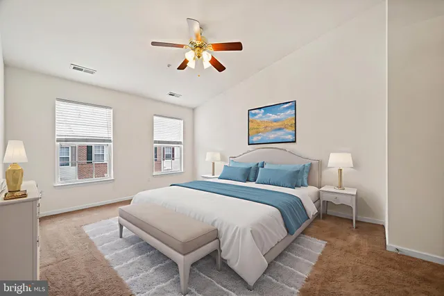 an empty room with windows and fan