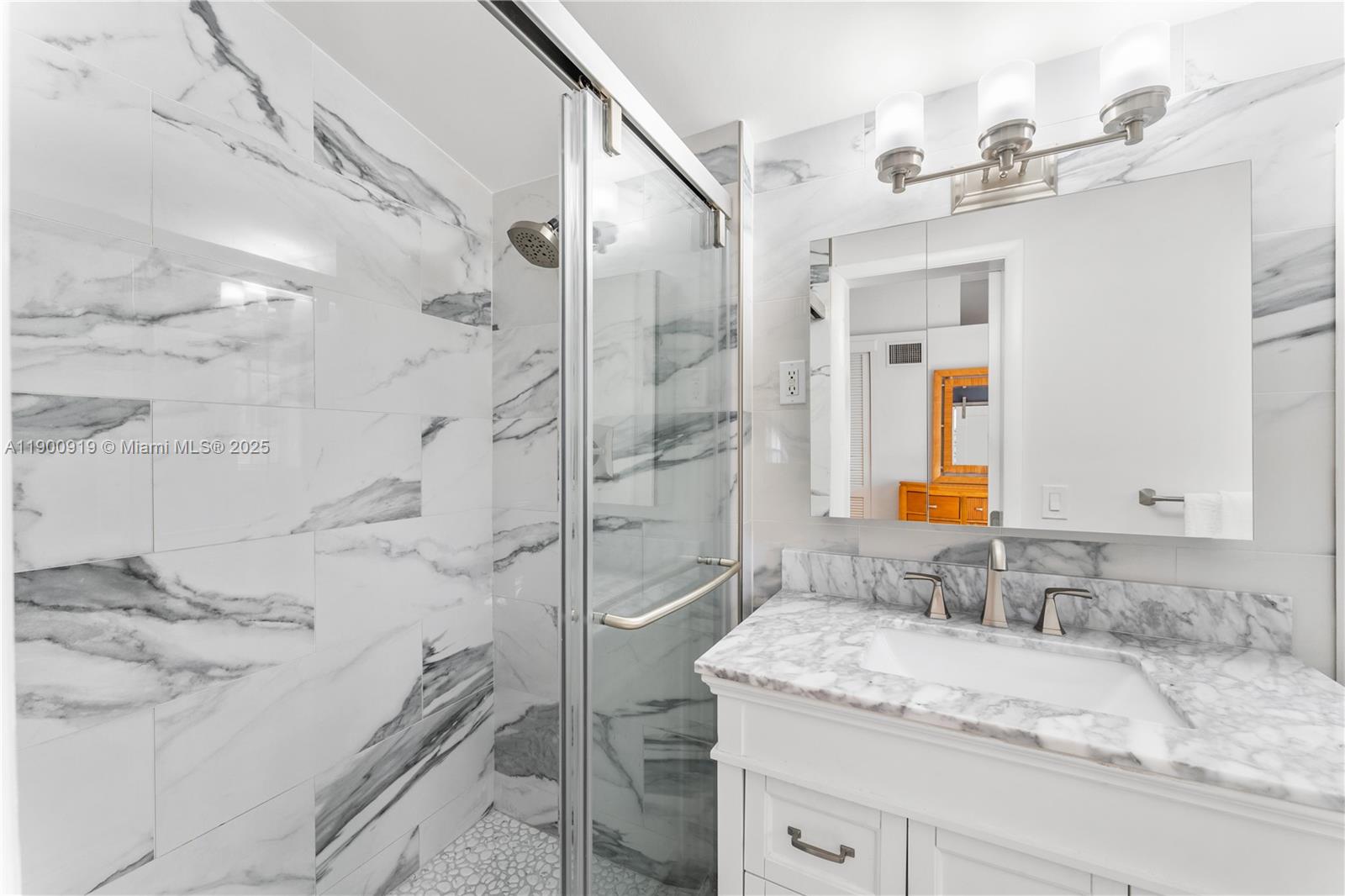 1625 Southwest 5th Court Fort Lauderdale, FL 33312 - Photo 11 of 22 a bathroom with a granite countertop sink a mirror and a shower