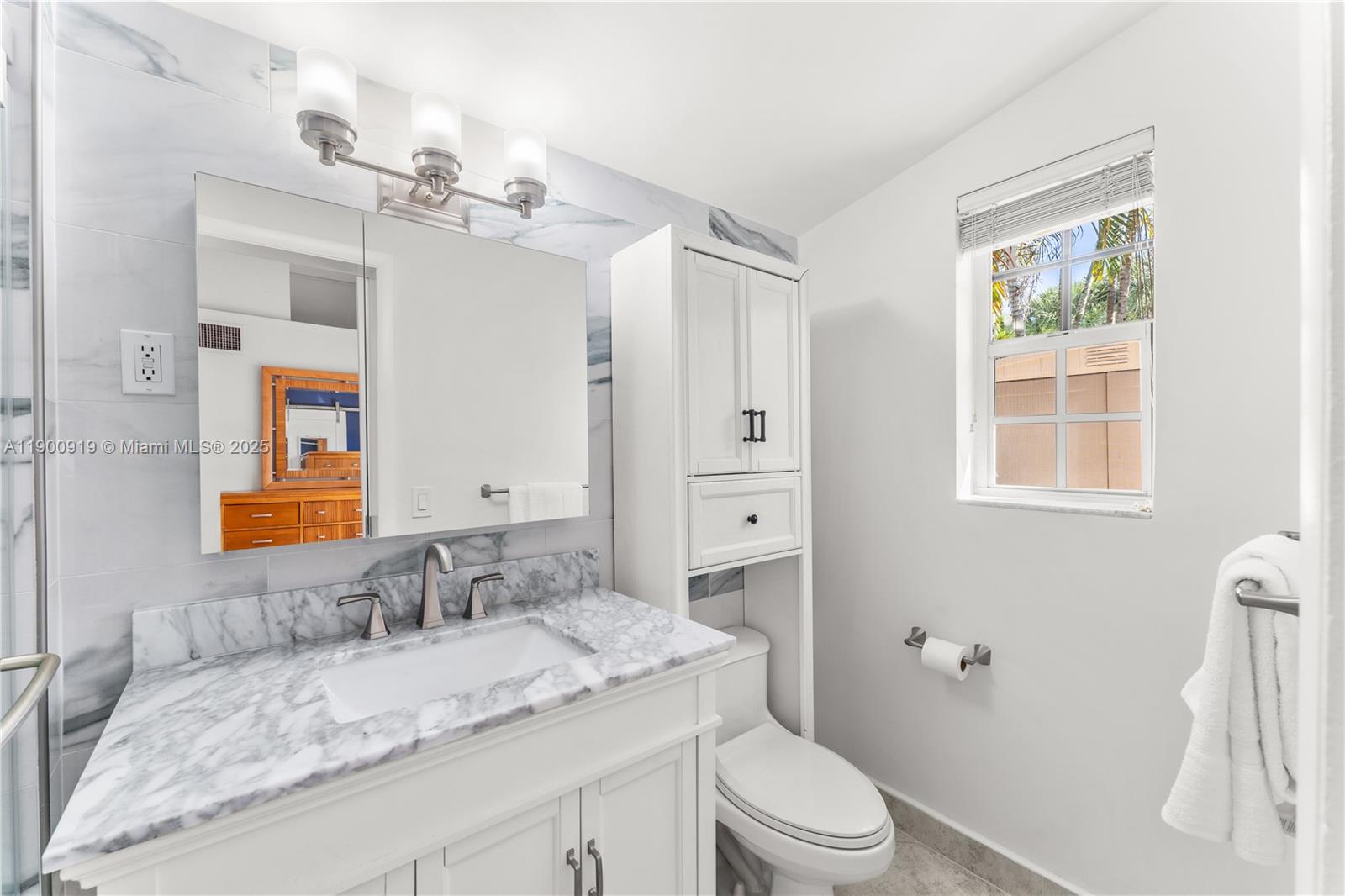 1625 Southwest 5th Court Fort Lauderdale, FL 33312 - Photo 12 of 22 a bathroom with a granite countertop sink toilet a mirror a vanity and shower