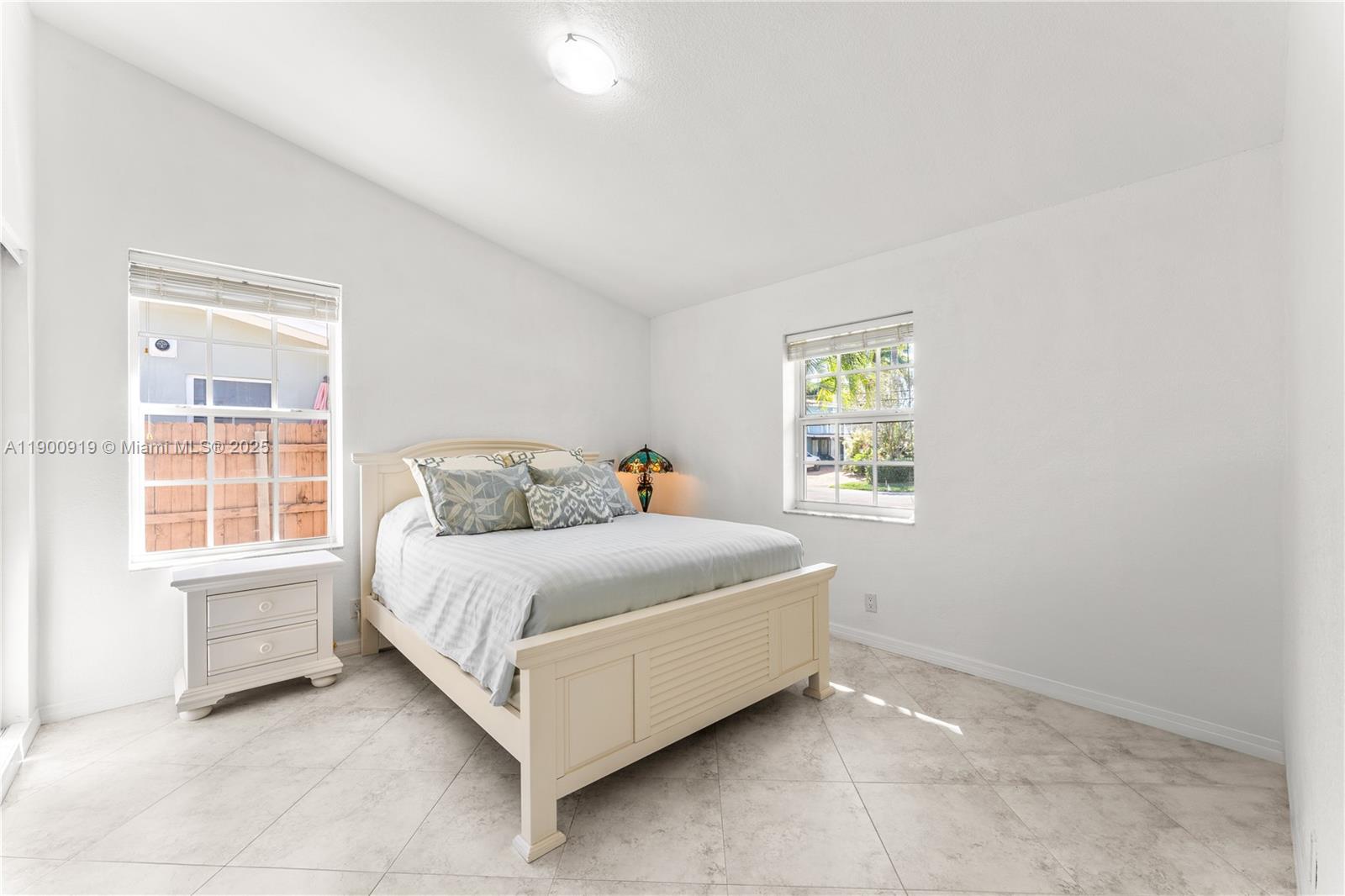 1625 Southwest 5th Court Fort Lauderdale, FL 33312 - Photo 13 of 22 a bed sitting in a bedroom next to a window