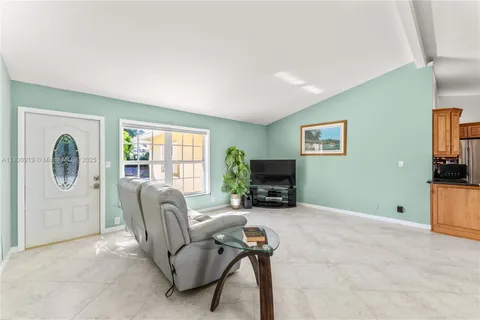 a view of a kitchen with kitchen island granite countertop lots of counter top space