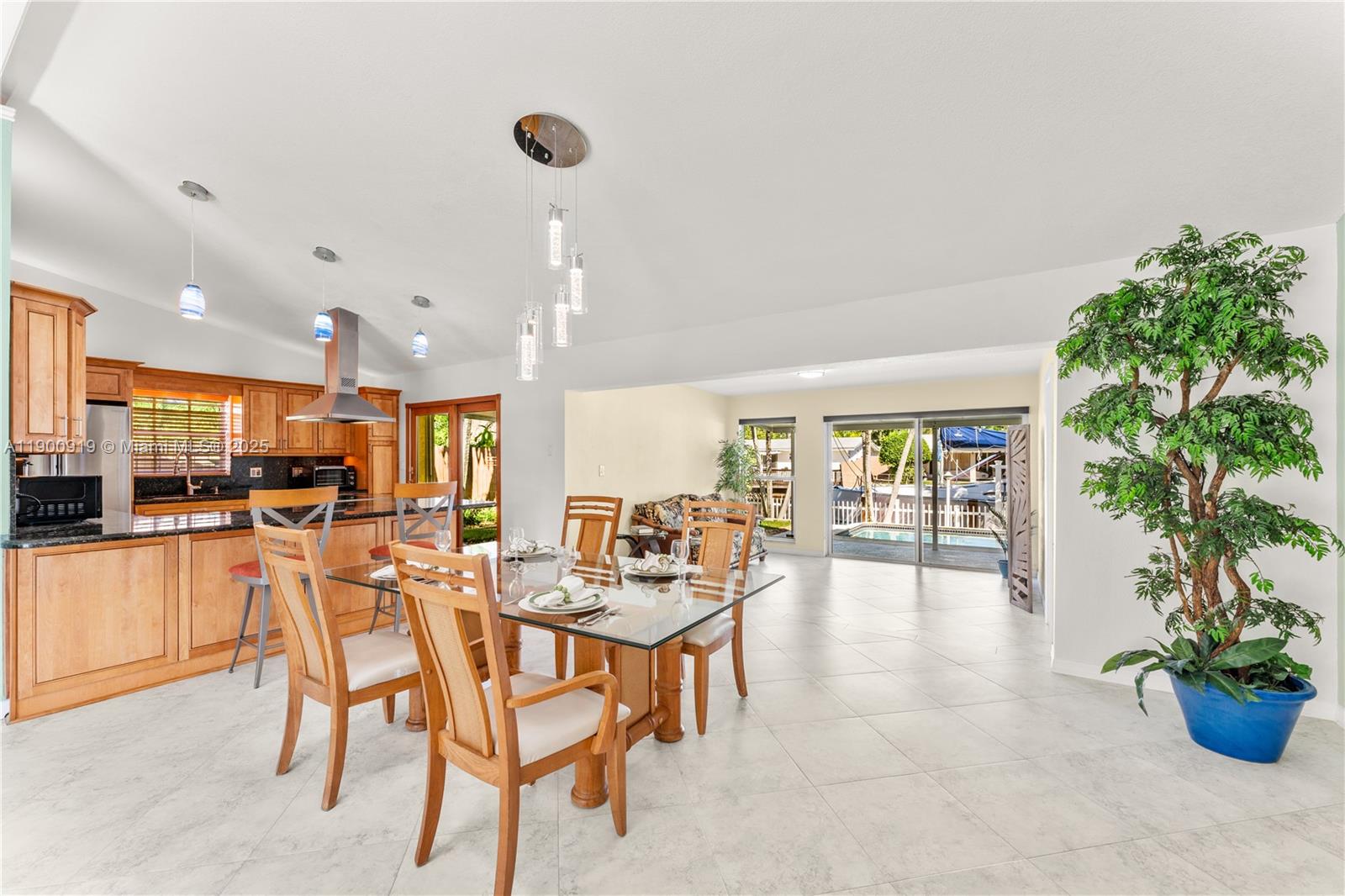 1625 Southwest 5th Court Fort Lauderdale, FL 33312 - Photo 7 of 22 a very nice looking dining room with kitchen island furniture and a potted plant